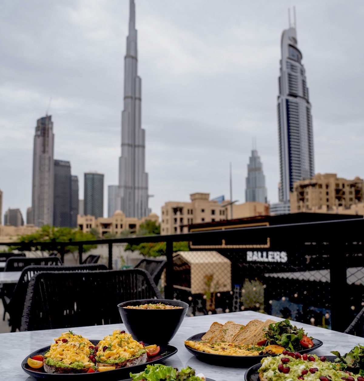 Terrace table at Ballers Cafe with the Burj Khalifa beyond